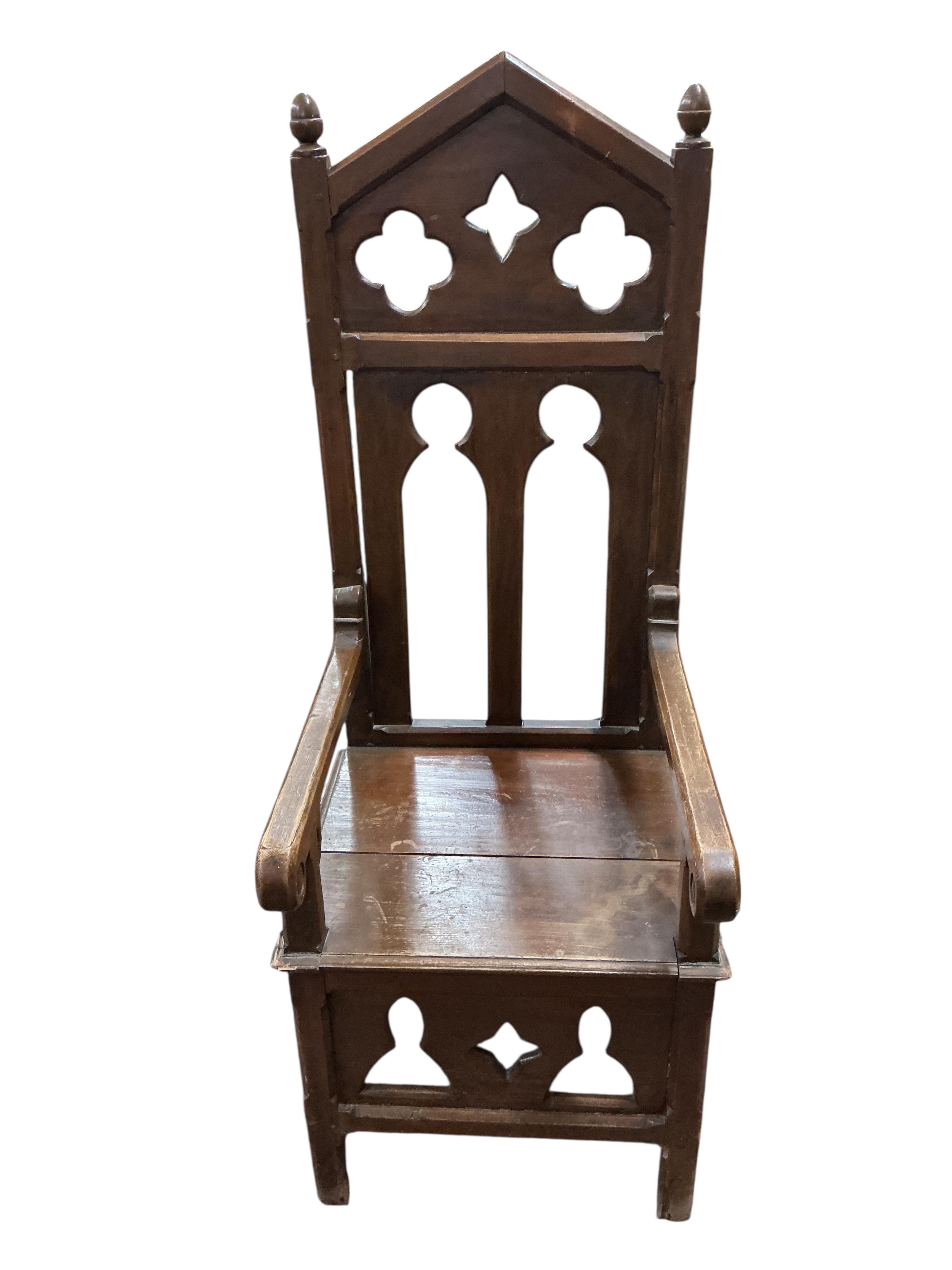 A pair of Gothic style ecclesiastical pine high back elbow chairs, width 52cm, depth 60cm, height 143cm
